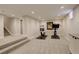 Finished basement with carpeting and recessed lighting, plus gym equipment for a private workout area at 2568 Clermont St, Denver, CO 80207