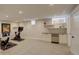 Finished basement featuring carpeted floors, bright lighting, and gym equipment, plus a bar with beverage cooler at 2568 Clermont St, Denver, CO 80207