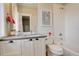 Stylish bathroom featuring sleek cabinets, a neutral countertop, a mirror and a bathtub with white subway tile at 2568 Clermont St, Denver, CO 80207
