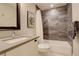 Bathroom featuring modern sink, gray tiled wall and shower/tub combination at 2568 Clermont St, Denver, CO 80207