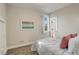 Cozy bedroom with carpet, a large window, and a view of the ensuite bathroom, showcasing a relaxing retreat at 2568 Clermont St, Denver, CO 80207