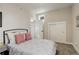 Comfortable bedroom featuring a bright window, plush pillows, and a closet with sliding doors for storage at 2568 Clermont St, Denver, CO 80207