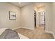 Neutral bedroom with carpet floors, light walls and ceilings, with view into a spacious walk-in closet at 2568 Clermont St, Denver, CO 80207