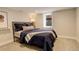 Cozy bedroom featuring a comfortable bed, neutral walls, and a sunny window at 2568 Clermont St, Denver, CO 80207