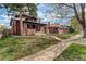Inviting front of brick house with lawn and trees at 2568 Clermont St, Denver, CO 80207