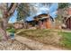 Charming brick home with mature trees, a front lawn, and inviting walkway at 2568 Clermont St, Denver, CO 80207