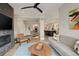 Open concept living room flows into the kitchen with modern finishes and cozy decor at 2568 Clermont St, Denver, CO 80207