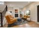 Bright living room with a modern fireplace, hardwood floors, and plenty of natural light at 2568 Clermont St, Denver, CO 80207