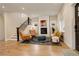 Inviting living room featuring a cozy fireplace, wood floors, and a staircase at 2568 Clermont St, Denver, CO 80207