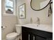 Stylish powder room featuring a sleek vanity, modern fixtures, and ample natural light at 2568 Clermont St, Denver, CO 80207