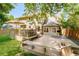 Spacious backyard with large wooden deck, patio seating, and landscaped lawn, perfect for outdoor entertaining at 16438 E Prentice Cir, Centennial, CO 80015