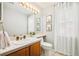 Light and airy bathroom featuring a decorative light fixture over vanity and plants for a spa-like feel at 16438 E Prentice Cir, Centennial, CO 80015