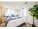 Serene bedroom featuring soft natural light, plush pillows, and a cozy purple throw blanket at 16438 E Prentice Cir, Centennial, CO 80015
