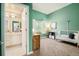 Bright bedroom with green walls, a window, and a view into the attached bathroom at 16438 E Prentice Cir, Centennial, CO 80015