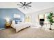 Bright bedroom with a vaulted ceiling, modern desk, and serene blue accent wall at 16438 E Prentice Cir, Centennial, CO 80015