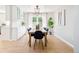 Elegant dining room featuring hardwood floors, modern lighting, and view into the kitchen and living room at 16438 E Prentice Cir, Centennial, CO 80015