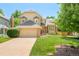 Inviting two-story home showcasing lush green lawn, two-car garage, mature trees and desirable neighborhood at 16438 E Prentice Cir, Centennial, CO 80015