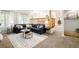 Bright living room features a comfortable sectional sofa, decorative rug, and seamless flow to the dining area at 16438 E Prentice Cir, Centennial, CO 80015