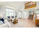 Spacious living room with large windows, hardwood floors, neutral decor, and staircase to the second level at 16438 E Prentice Cir, Centennial, CO 80015