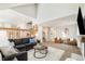 Open-concept living room with comfortable furniture, wooden railing, and plenty of natural light at 16438 E Prentice Cir, Centennial, CO 80015