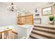 Staircase with carpeted steps, a stylish chandelier, and natural light from a nearby window at 16438 E Prentice Cir, Centennial, CO 80015