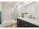 Clean and bright bathroom featuring modern vanity with ample storage, shower over tub, and sleek fixtures at 745 S Alton Way # 11A, Denver, CO 80247