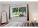 Bright bedroom featuring a large window with views of community greenery and plenty of natural light at 745 S Alton Way # 11A, Denver, CO 80247