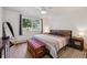 Comfortable bedroom with a ceiling fan, a large window with a view, and a cozy wooden chest at 745 S Alton Way # 11A, Denver, CO 80247