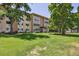 Well-kept apartment building with lush green lawns and mature trees providing a tranquil atmosphere at 745 S Alton Way # 11A, Denver, CO 80247