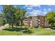 Attractive apartment building surrounded by mature trees and a green lawn, offering a serene living environment at 745 S Alton Way # 11A, Denver, CO 80247