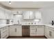 Renovated kitchen features white cabinetry, modern appliances, and updated countertops at 745 S Alton Way # 11A, Denver, CO 80247