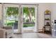 Bright living room featuring sliding glass doors that open to a patio and community green space at 745 S Alton Way # 11A, Denver, CO 80247