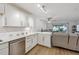 Open concept living and kitchen area with light-colored wood floors and modern furnishings at 745 S Alton Way # 11A, Denver, CO 80247