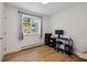 Well-lit home office featuring wood-look floors, a window with a view, and a modern workstation at 745 S Alton Way # 11A, Denver, CO 80247