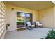 Charming patio with rocking chairs, a welcome mat and sliding glass door provides a relaxing outdoor space at 745 S Alton Way # 11A, Denver, CO 80247