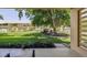 Relaxing view of mature trees and manicured lawn from a covered outdoor patio at 745 S Alton Way # 11A, Denver, CO 80247