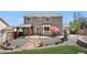 Exterior view of a home with a landscaped backyard, covered patio and outdoor seating at 3761 S Orleans St, Aurora, CO 80013
