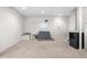 Spacious carpeted basement featuring neutral walls, ample room, and a mini refrigerator at 3761 S Orleans St, Aurora, CO 80013