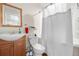 Cozy bathroom featuring a shower with tub, white tile, and a single sink vanity at 3761 S Orleans St, Aurora, CO 80013