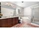 Bathroom featuring a marble countertop, a bathtub, and a glass-enclosed shower for a spa-like experience at 3761 S Orleans St, Aurora, CO 80013