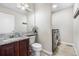 Bathroom featuring a sink with marble countertop, a modern toilet, and a laundry area with gray washer and dryer at 3761 S Orleans St, Aurora, CO 80013