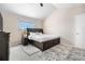 Bedroom features a plush bed, vaulted ceiling, a ceiling fan and a window with natural light at 3761 S Orleans St, Aurora, CO 80013