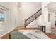 Bright foyer with a hardwood floor, a staircase, and a view of the front door at 3761 S Orleans St, Aurora, CO 80013