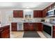 Spacious kitchen with stainless steel appliances, custom cabinets, and ample counter space at 3761 S Orleans St, Aurora, CO 80013