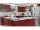 Bright kitchen featuring stainless steel appliances, marble countertops, and warm wood cabinets with ample storage at 3761 S Orleans St, Aurora, CO 80013