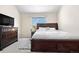 Bedroom features a large bed with built-in storage, a TV, and a window providing natural light at 3761 S Orleans St, Aurora, CO 80013