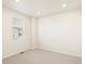 Bright bedroom featuring neutral carpet, a window with blinds, and clean, neutral walls at 17417 E 89Th Way, Commerce City, CO 80022