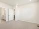 Spacious bedroom with neutral carpet and light walls, connected to a bathroom and other rooms at 17417 E 89Th Way, Commerce City, CO 80022