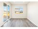 The bedroom has vinyl flooring and large window and sliding door that brings in lots of light at 17417 E 89Th Way, Commerce City, CO 80022