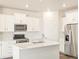 Bright kitchen features white cabinets, stainless steel appliances, and a stylish tile backsplash at 17417 E 89Th Way, Commerce City, CO 80022